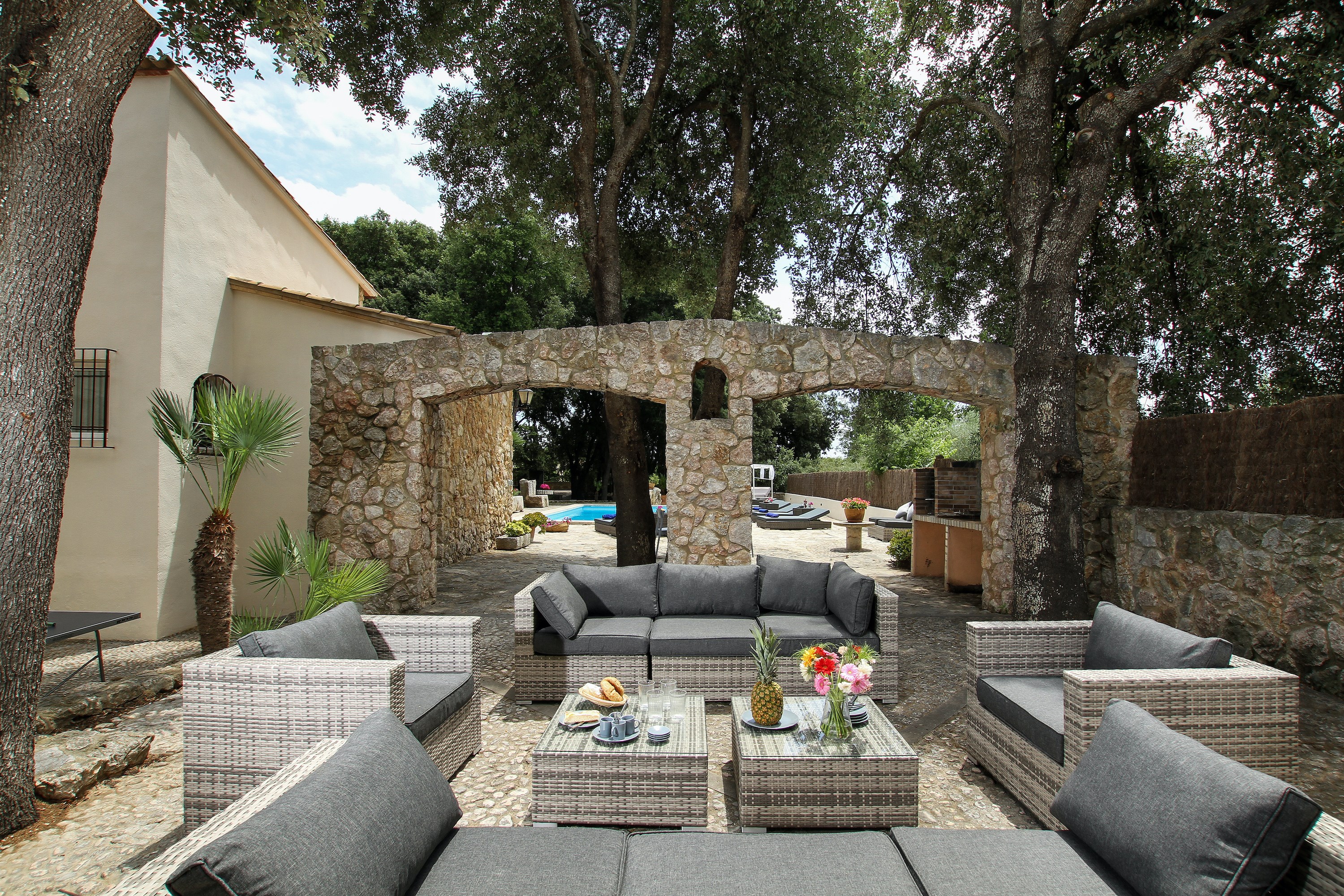 The stone double arch and terrace at Villa Las Encinas
